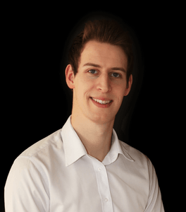 Picture of Daniel Tannenbaum, brown haired white man smiling, wearing a white shirt