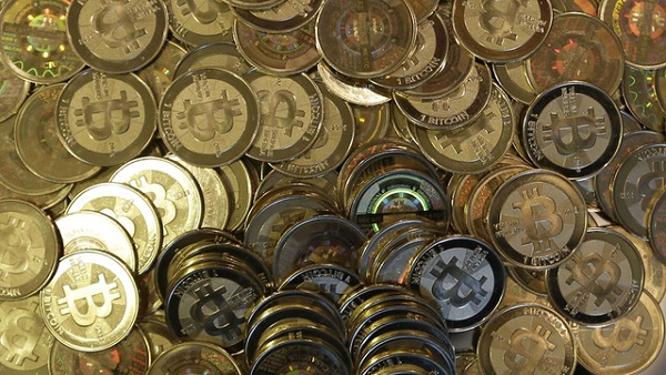 This April 3, 2013 photo shows bitcoin tokens at 35-year-old software engineer Mike Caldwell's shop in Sandy, Utah. Caldwell mints physical versions of bitcoins, cranking out homemade tokens with codes protected by tamper-proof holographic seals, a retro-futuristic kind of prepaid cash. With up to 70,000 transactions each day over the past month, bitcoins have been propelled from the world of Internet oddities to the cusp of mainstream use, a remarkable breakthrough for a currency which made its online debut only four years ago. (AP Photo/Rick Bowmer)